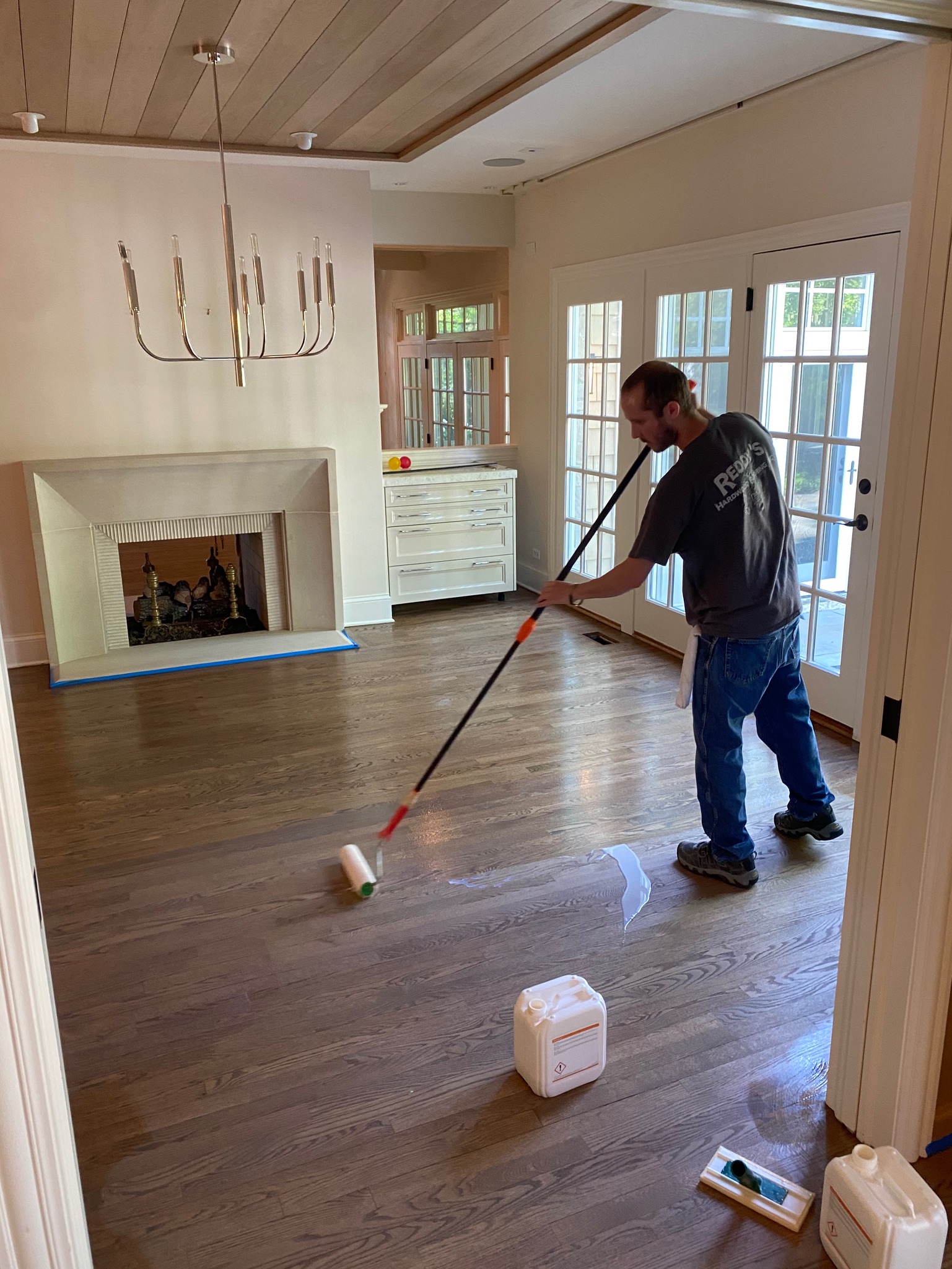 Refinishing-a-hardwood-floor-and-putting-final-coat-of-finish-on